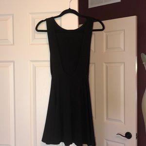 Black like new dress with low cut sides and back.